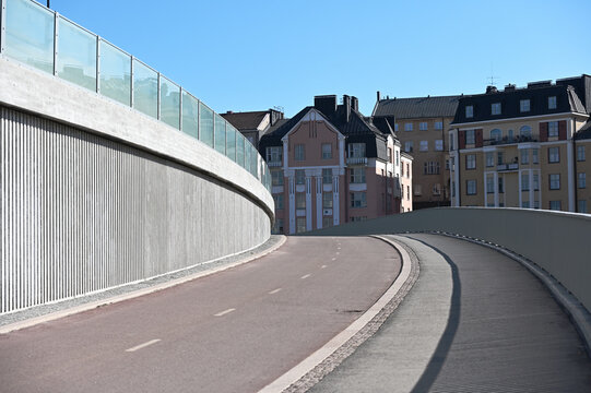 Curved road and pedestrian path on a modern bridge in Helsinki, Finland