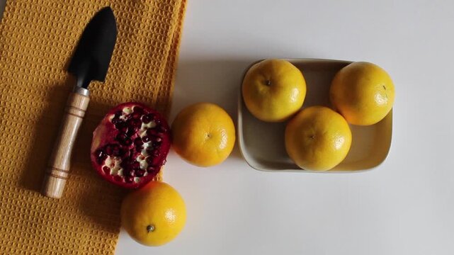 Pomegranate and oranges on Plate Minimal Food Scene