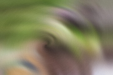 Fototapeta premium Blurry green and purple abstract image with swirly pattern