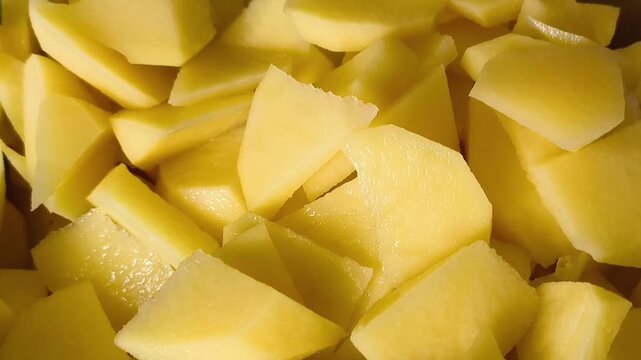 Sliced potatoes in a cup. The process of baking potatoes in the oven. starch