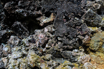Obraz premium Macro close-up of dark basaltic volcano rock. Abstract geological background for nature, landscape, or design themes.