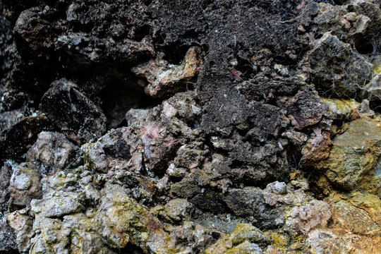 Macro close-up of dark basaltic volcano rock. Abstract geological background for nature, landscape, or design themes.