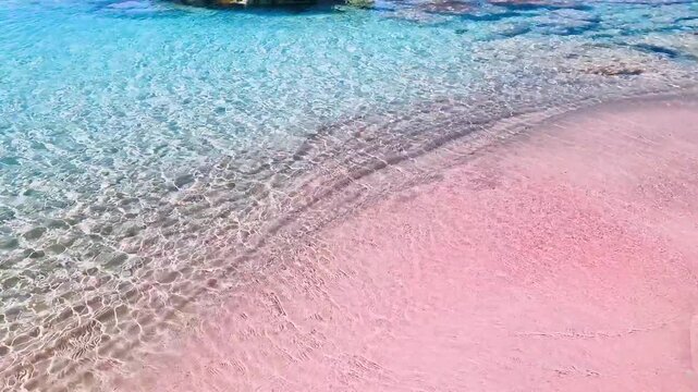 Greece Crete 4K Video of Unreal Pink Sand Close Up and Lifting to Turquoise Sea with Black Rocks Empty Dreamlike Elafonisi Beach Scenic Exotic Nature Travel