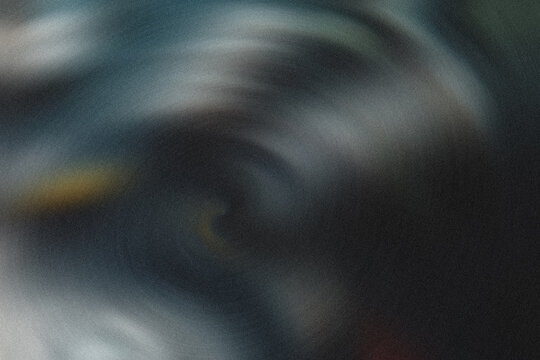A dark and blurry image with shades of blue and yellow light