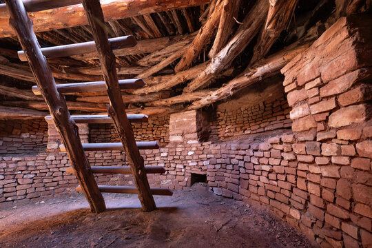 Ancient underground kiva interior with wooden ladder, Three Kiva Pueblo, Utah