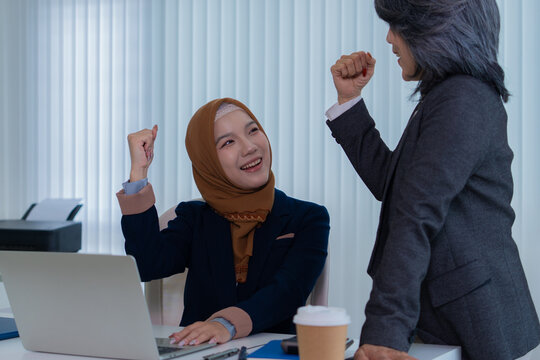 Muslim female applicant consulting with hiring manager in modern