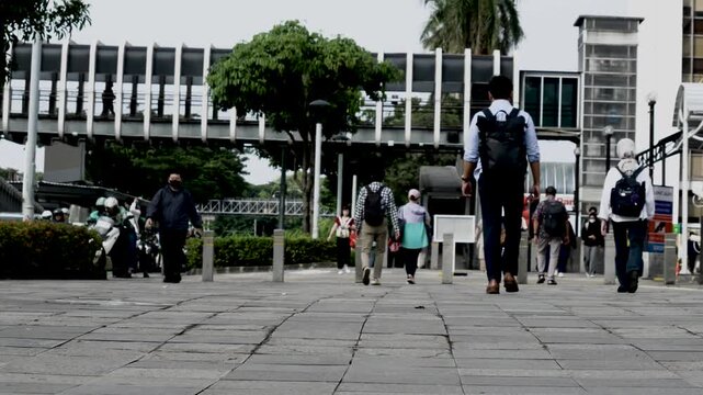 Jakarta, Indonesia, March 2 2026. Pedestrians on the sidewalk on their way to work 05