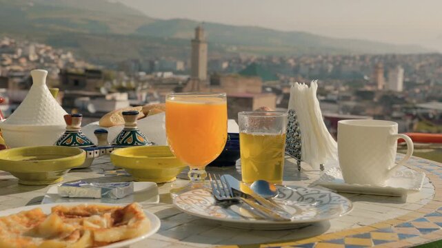 Traditional moroccan breakfast on a rooftop terrace overlooking the medina of Fez, Morocco