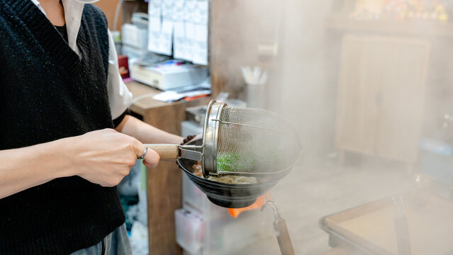 Restaurant chef handling steaming dumplings
