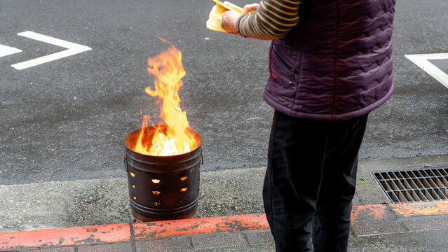 Taiwanese joss paper burning outside a restaurant