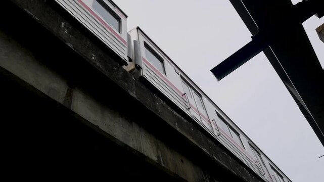 Bintaro, Tangerang Selatan, Indonesia April 25, 2026. Seen from the bottom angle, the commuter line train is moving over the bridge 02