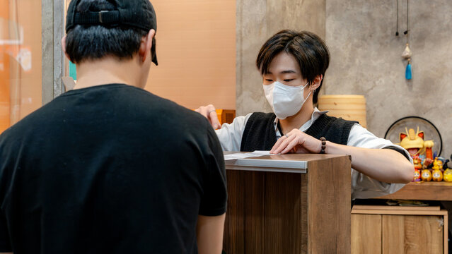 Taiwanese restaurant staff interacting at counter