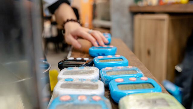 Digital timers in a row on restaurant counter