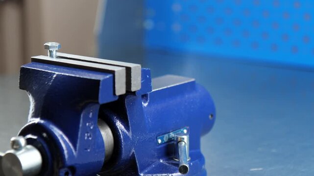 Metal vise fixed on a metal table.