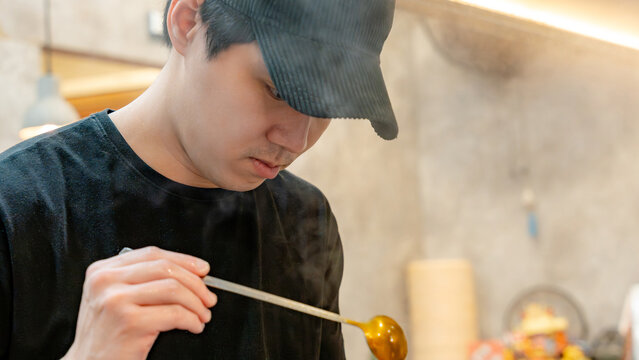 Chef preparing dish in taiwanese restaurant kitchen