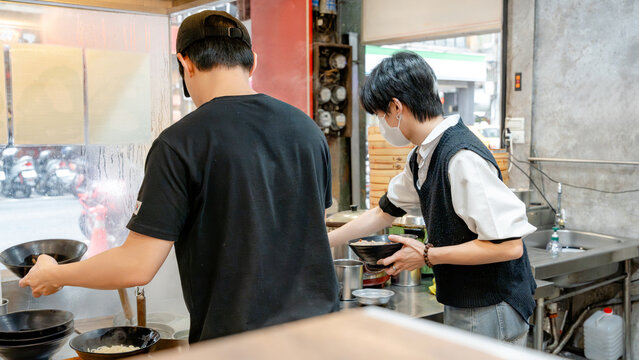 Taiwanese chefs preparing dishes in a local restaurant