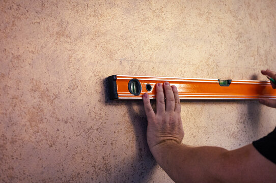 male hands with a ruler level