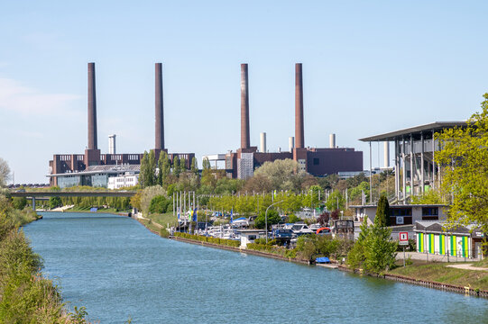 WOLFSBURG, GERMANY - 28 April 2026: View of Wolfsburg Volkswagen plant (factory) from the canal on a sunny day