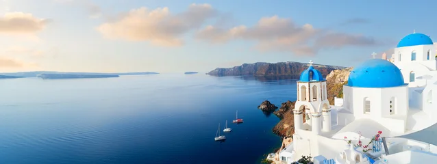 white church belfry, blue domes and volcano caldera with sea landscape, beautiful details of Santorini island, Greece, web banner format © neirfy