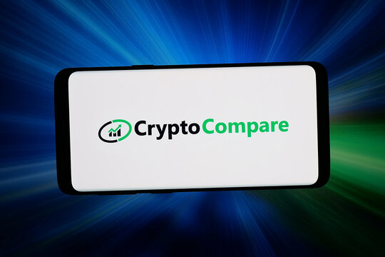 Stuttgart, Germany - 04-16-2026: In this photo illustration, the logo of cryptocurrency company CryptoCompare is displayed on a smartphone in front of abstract background on computer screen.