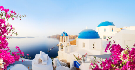traditional greek village Oia of Santorini, with blue domes against sea and caldera, Greece, web banner format © neirfy