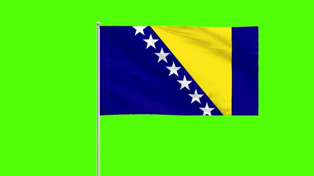 Bosnian Flag Waving: The vibrant flag of Bosnia and Herzegovina flutters elegantly against a vivid green backdrop. Its blue field, adorned with a row of stars and a distinctive yellow triangle.