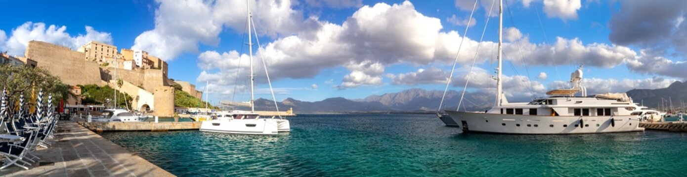 Calvi Corsica 16K Panorama, Medieval Fortress and Promenade with Empty Tables at Sunset, Luxury Sailing Yachts in Harbor under Dramatic Cloudy Sky, French Island Travel Destination High Res