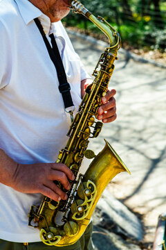Man playing a saxophone in Central Park in New York City 
