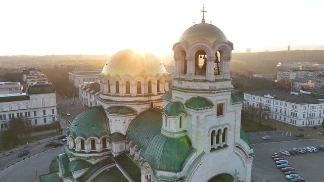 Аerial view of the capital of Bulgaria - Sofia. Iconic building. Close-up and backlight view of the St. Alexander Nevsky Cathedral at sunrise or sunset. The largest church in the Balkans. Movement.