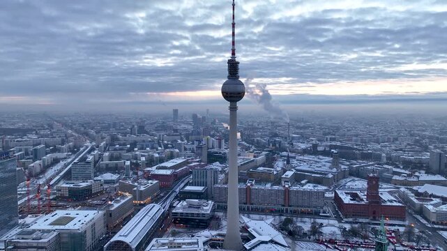 City of Berlin, Germany from above. Aerial winter cityscape view at sunrise or sunset, showing architectural landmarks Oberbaum Bridge, TV Tower and Berlin Cathedral in winter. 