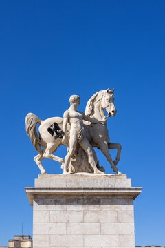 Paris, France - Sculpture of a Roman warrior by Louis-Joseph Daumas on top of a pylon on the Pont d'Iena next to the Eiffel Tower