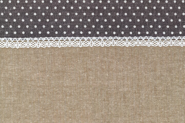 Fototapeta premium Fabric with polka dots and lace showing a sewing project in progress at home during daylight hours