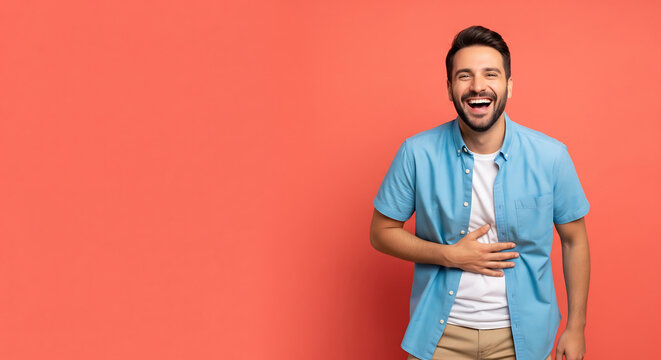 A man in a blue shirt makes a gesture on a studio flat background with copyspace.