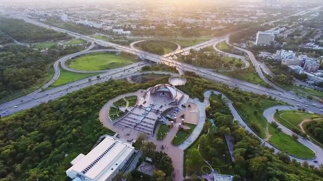 Aerial view of Pakistan Monument and complex highway cloverleaf interchange at sunset in Islamabad