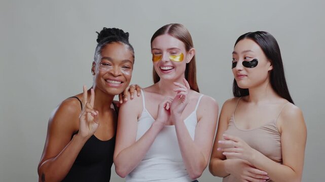 Group portrait of mixed-race beautiful diverse woman using eye patches healthy skincare cosmetics for fresh skin. Cosmetic ads. Fashion girls. Friendship.