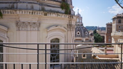 Balcony railing sharply focused with blurred domed rooftops and ornate building facades in soft bokeh city background  background backdrop copyspace calm. © Krakenimages.com