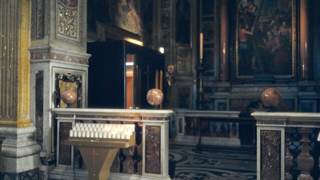 Ornate church interior with shallow bokeh and defocused marble altar, votive candles and carved columns, church; background backdrop copyspace calm.