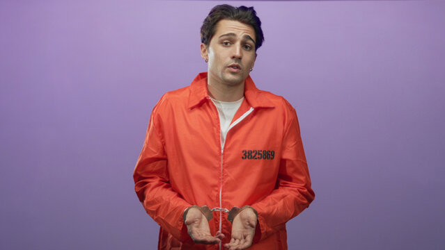 Man in orange jumpsuit stands with handcuffed hands held forward and inmate number visible on chest in studio; remorse consequence isolation.
