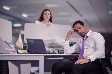 Naklejka premium Middle Eastern businessman in modern open office looking thoughtful during a corporate meeting with colleague