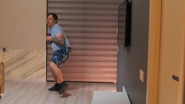 Man doing skater lunges with dumbbells at home, lateral leg workout improving balance and coordination, strength training for lower body, indoor fitness routine and healthy lifestyle concept