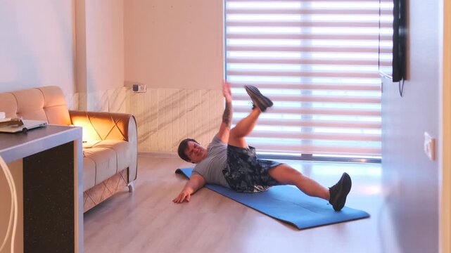 Man doing toe touch crunches on mat at home, abdominal workout targeting core muscles, indoor fitness routine for strength training, healthy lifestyle, home workout and body conditioning concept