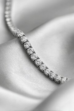 lab grown diamond tennis bracelet on white silk fabric background with round brilliant cut. Lab-grown diamonds industry. 