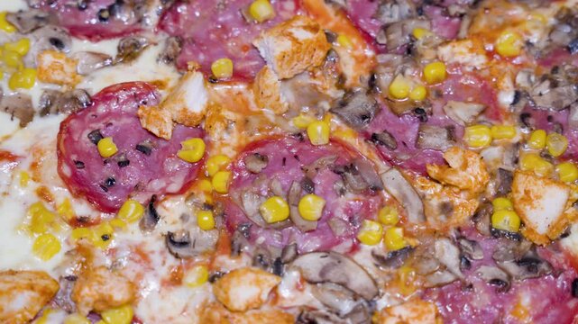 pizza toppings close up overhead for food background with melted cheese salami corn and baked surface texture