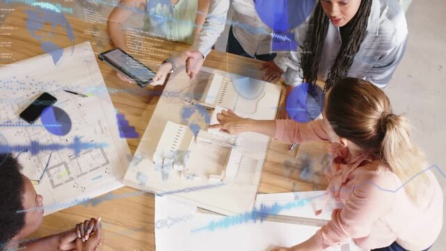 Design team five women pointing at model, holding tablet and causing blue overlays guiding design