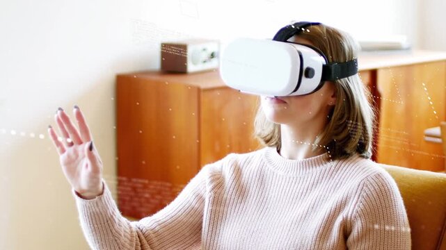 Woman wearing VR headset with ring ctrl raising hand, creating tech HUD, pinching pointing swiping