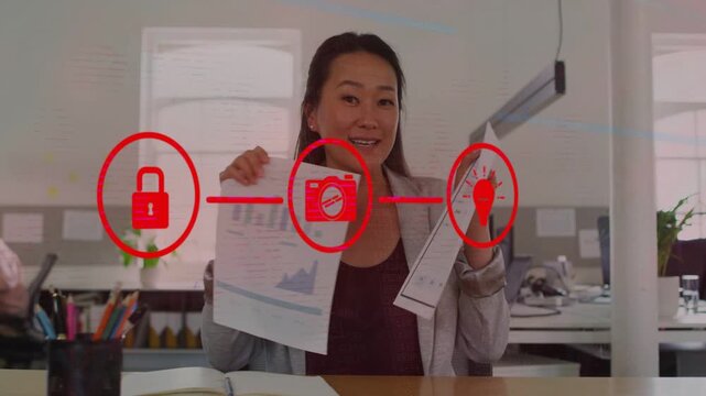 Woman presenting charts or table at desk, red icons linking, aligning with icons, explaining securit