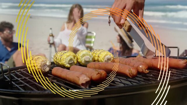 Hand reaching with tongs flipping dogs and corn on grill, animated rings showing food prep