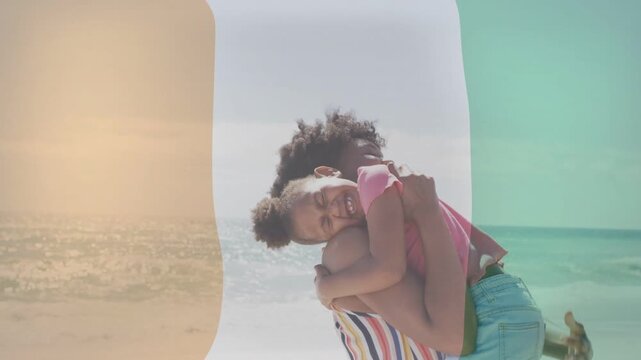 Mom shifting, lifting daughter by ocean, hugging while sweeping overlays tinting shot for lifestyle