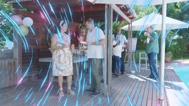 Pair clinking glasses on deck by pool man serving cake group toasting bluepink streaking over scene
