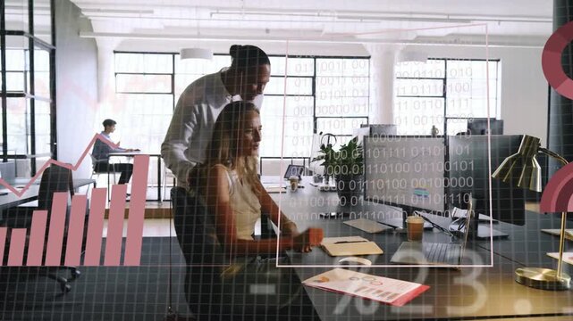 Standing mentor pointing screen, seated woman turning and typing, data charts guiding tech analysis